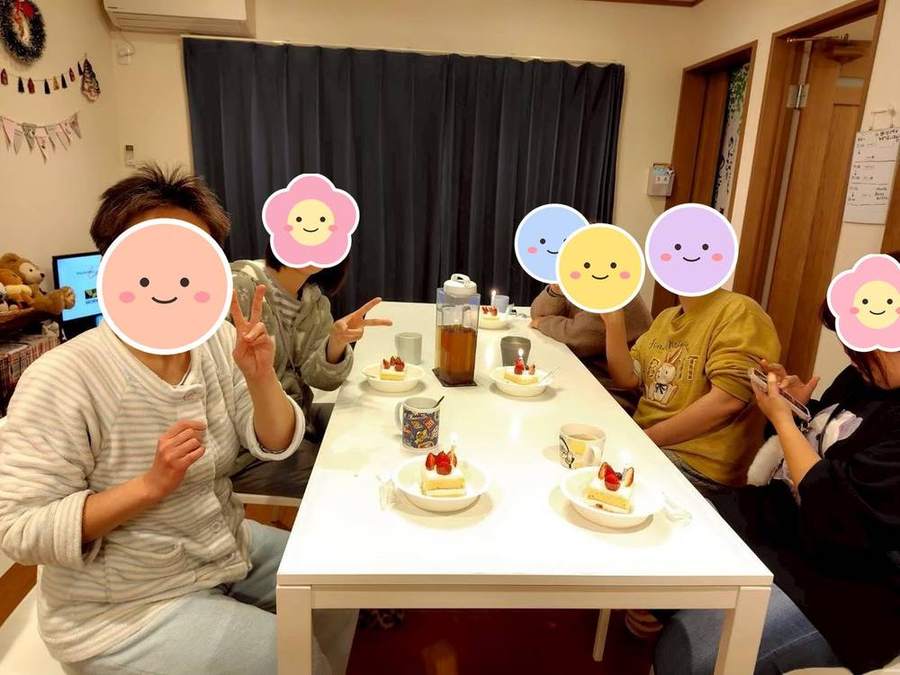 ケーキを前にピースする入居者さんたち